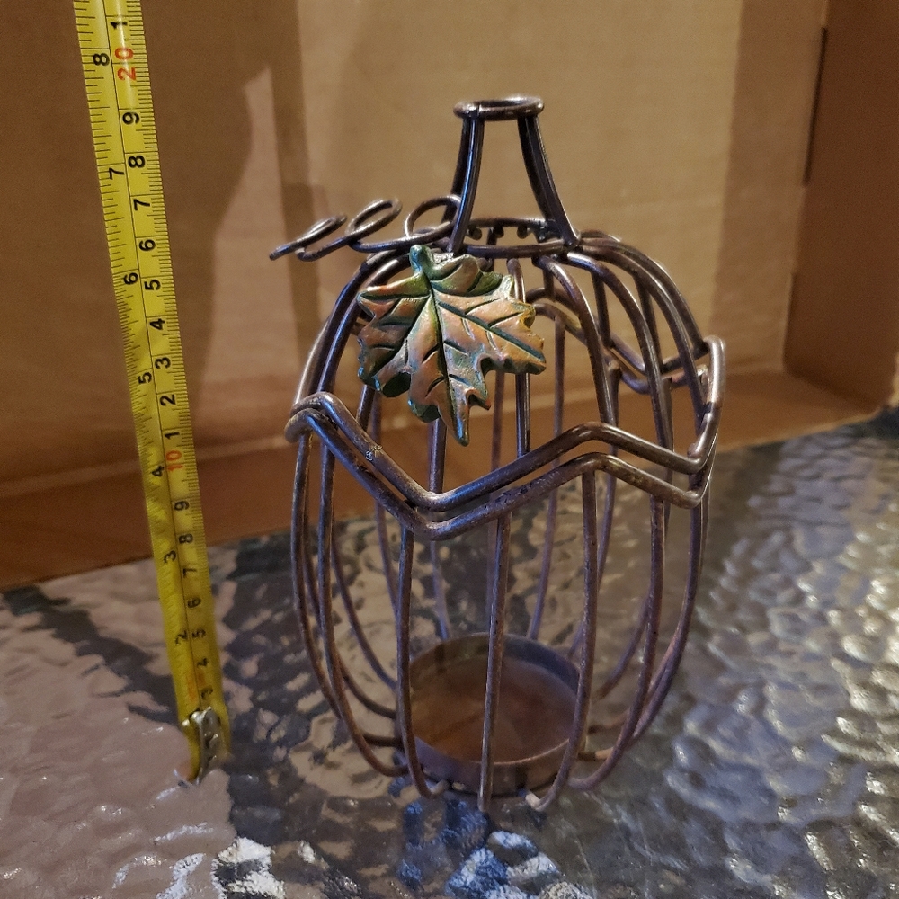 2 metal pumpkins , candle holders